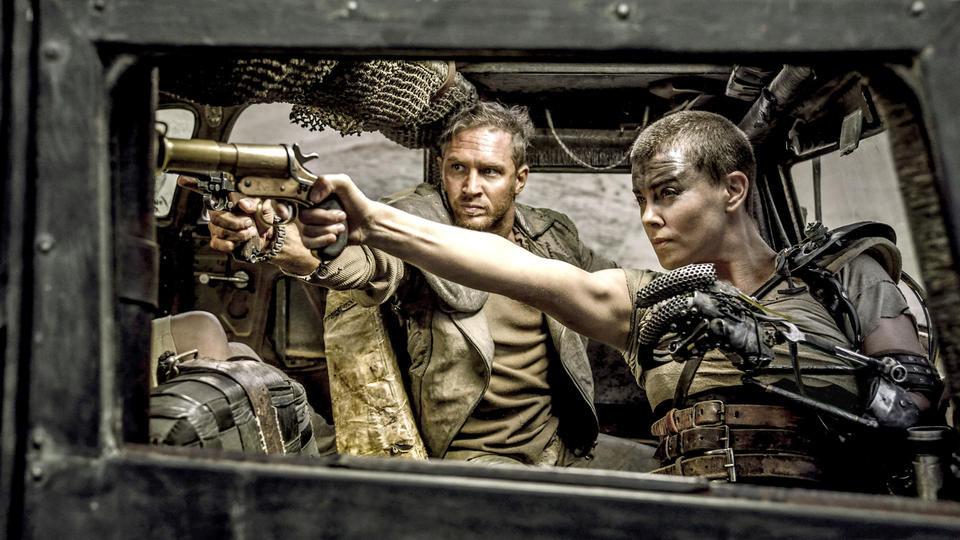 (L-r) TOM HARDY as Max Rockatansky and CHARLIZE THERON as Imperator Furiosa in Warner Bros. Pictures' and Village Roadshow Pictures' action adventure "MAD MAX: FURY ROAD," a Warner Bros. Pictures release. from Warner Bros. media site